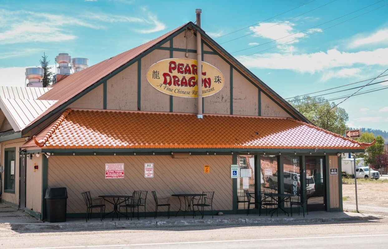 A quaint restaurant with a red-tiled roof and outdoor seating area in Grand County Colorado.