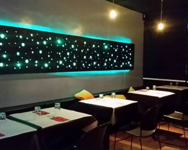 A modern restaurant interior with a starry night sky light display and minimalist decor in Grand County Colorado.