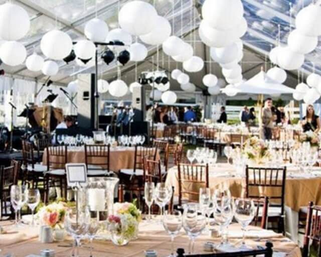 An elegant outdoor wedding reception with white lanterns and round tables in Grand County Colorado.