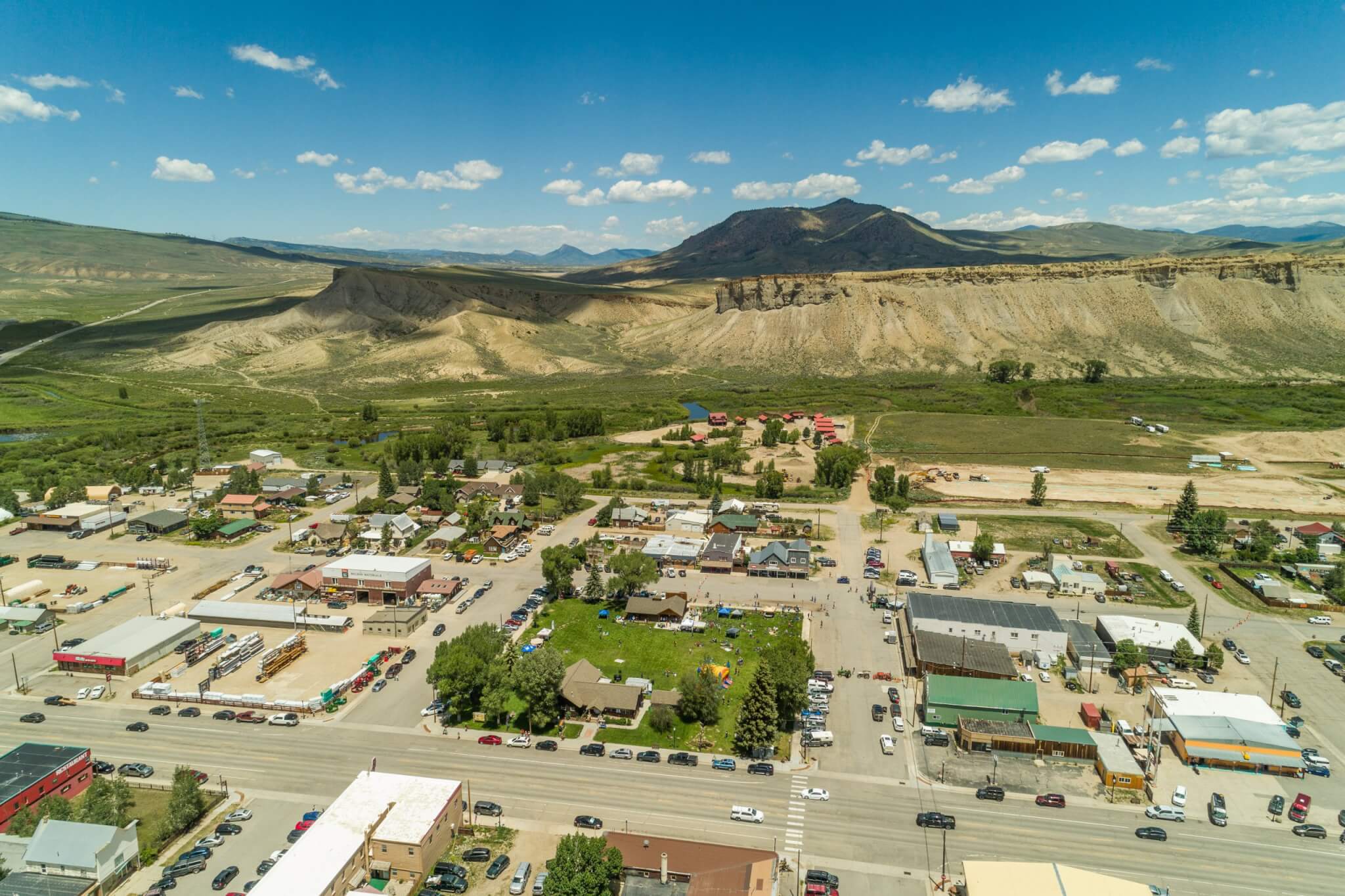 Aerial view of a small town nestled in a valley with mountains and desert landscapes in Grand County Colorado.