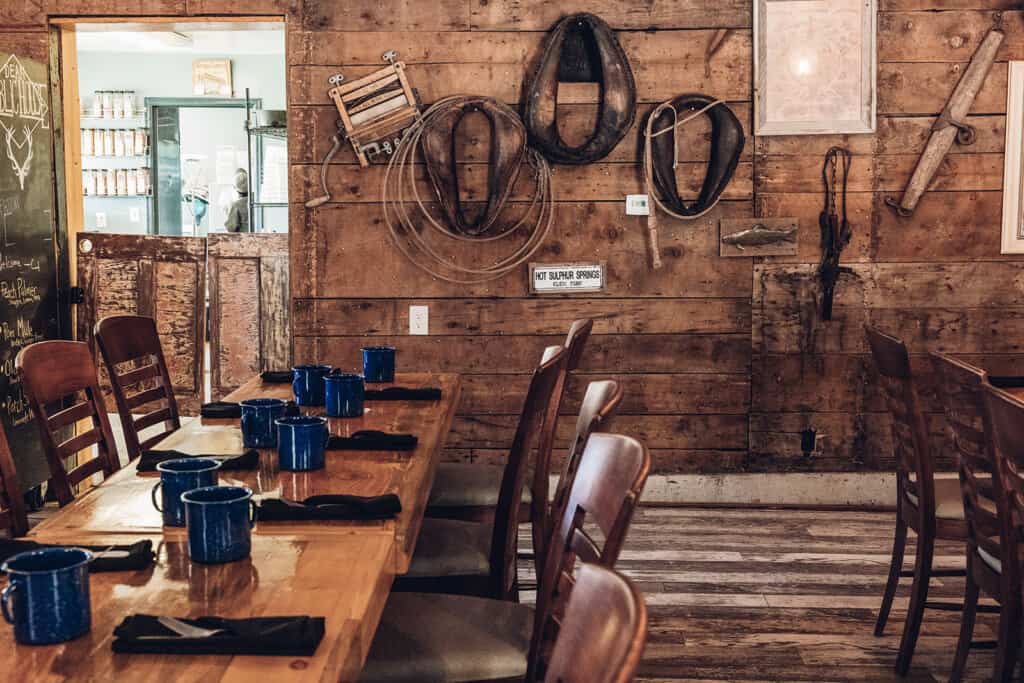 A dining room with wooden tables and chairs.