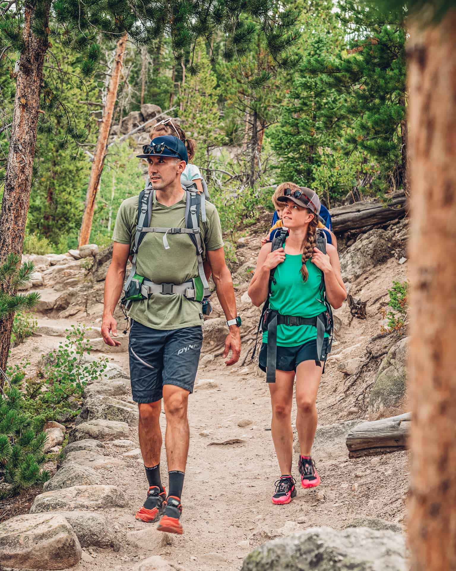 A man and woman hiking in the woods.