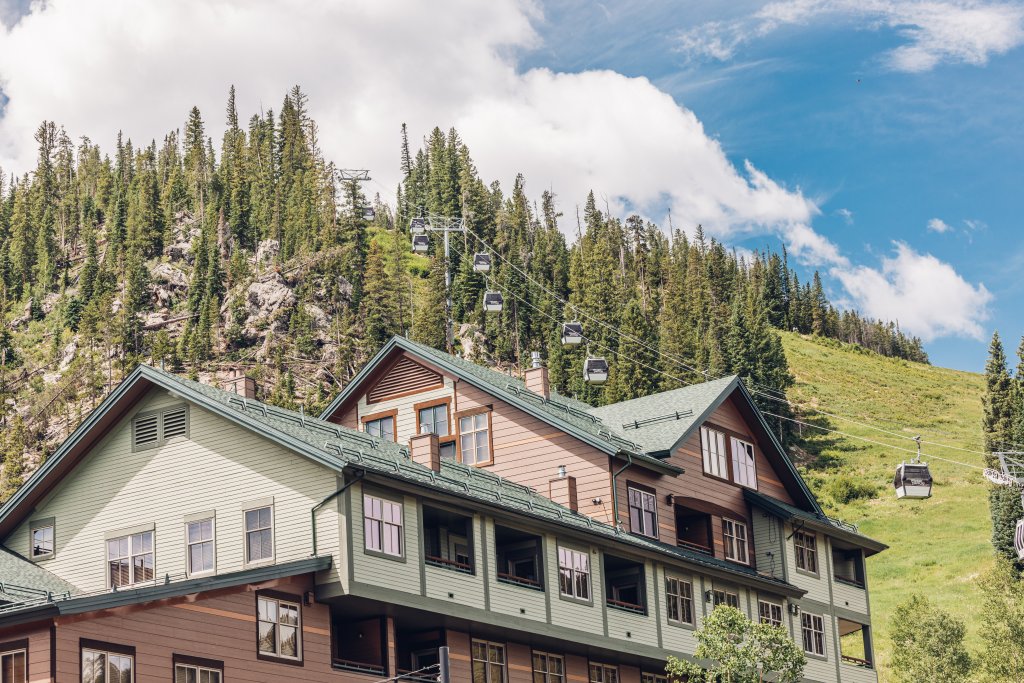 Winter Park Resort lodge with gondola on forested slope.