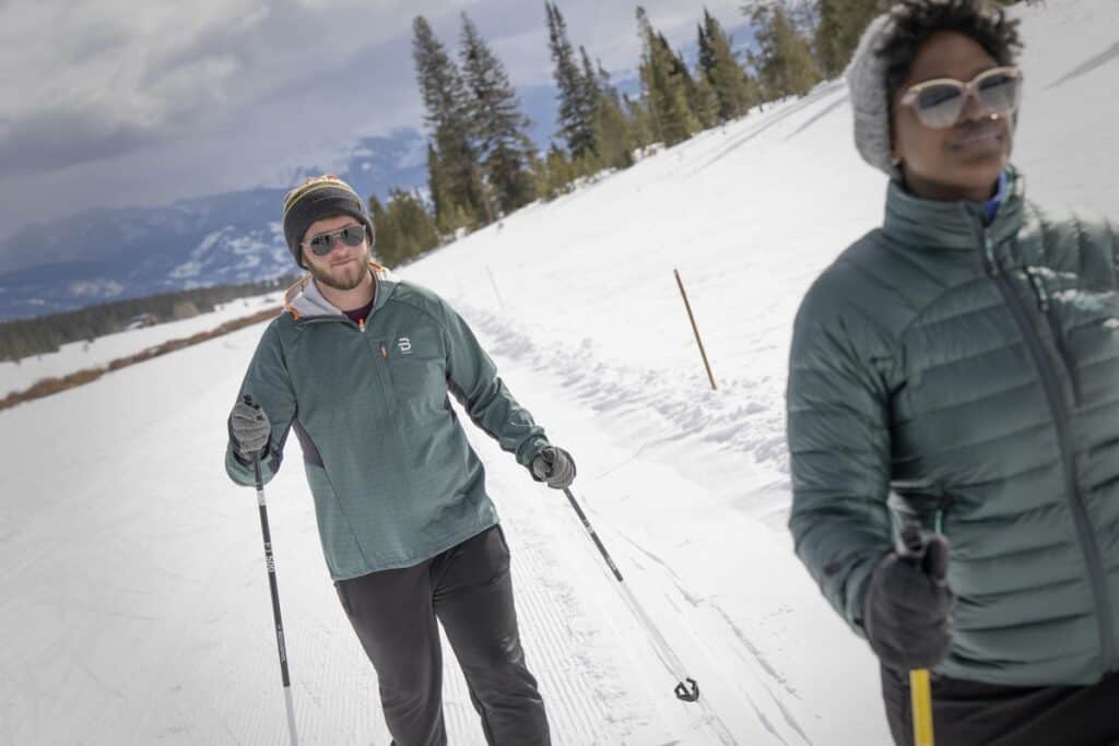 Two people snowshoeing on a snowy trail near Denver